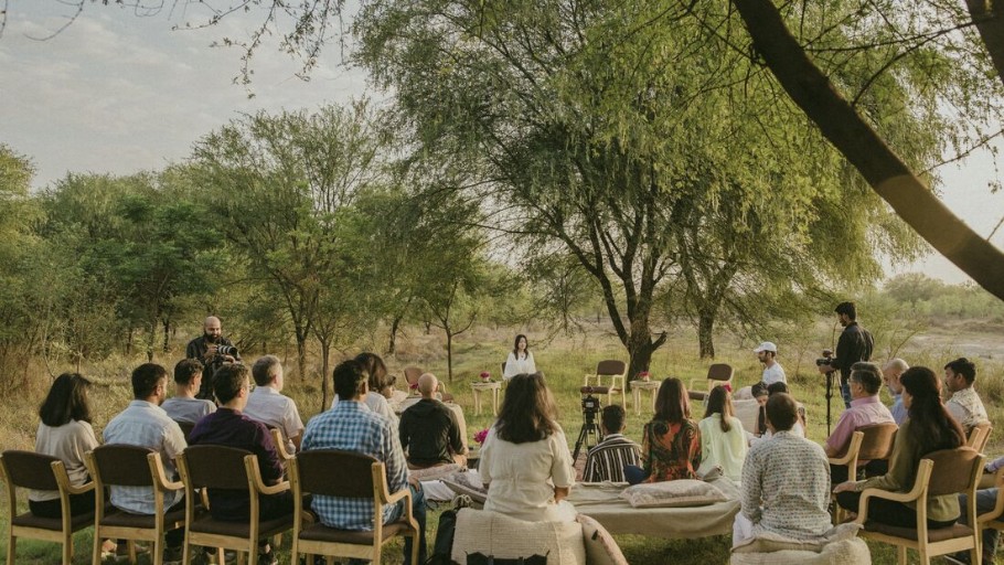Erin teaching an outdoor mindfulness session under trees in India