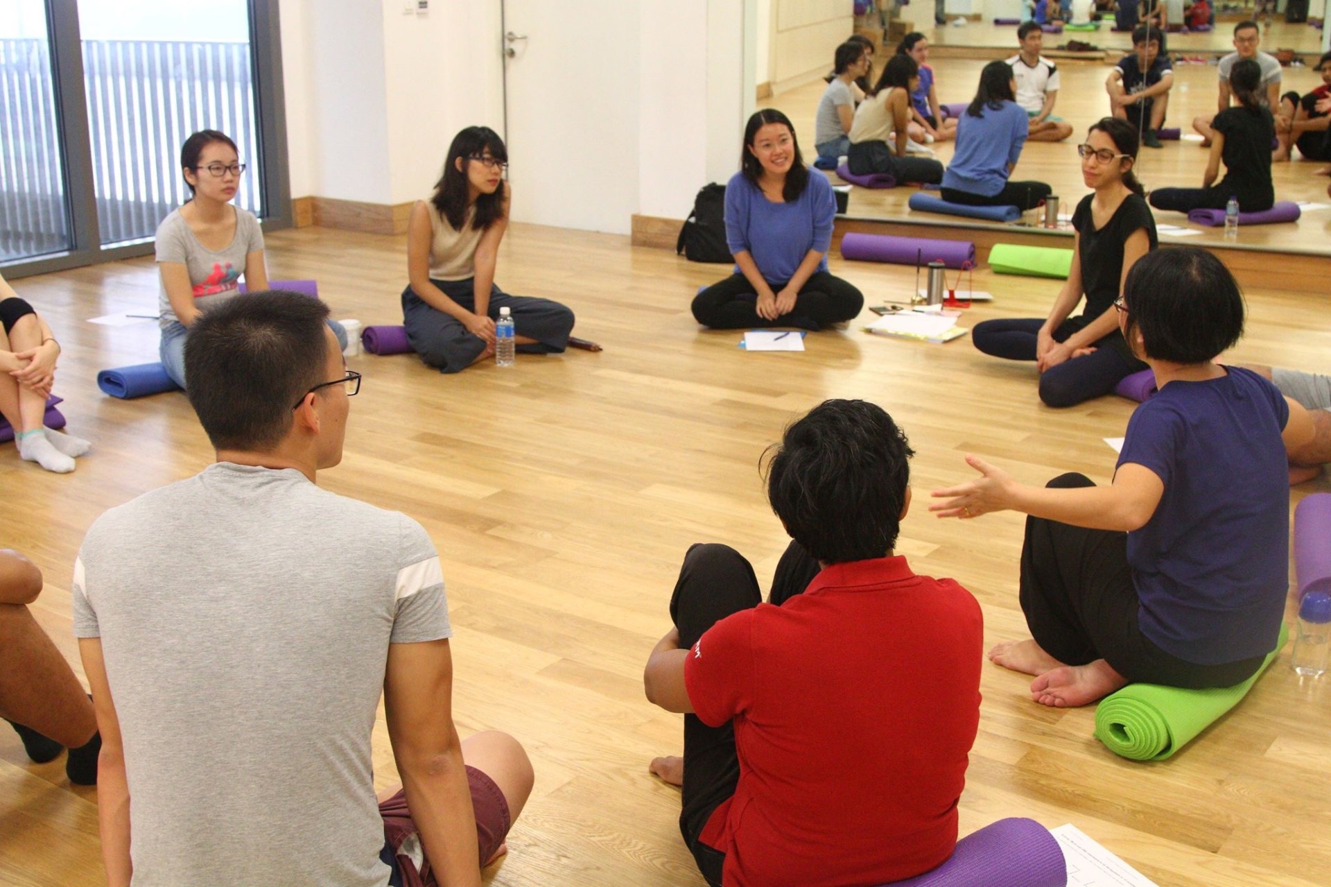 Erin leading a mindfulness circle at NUS