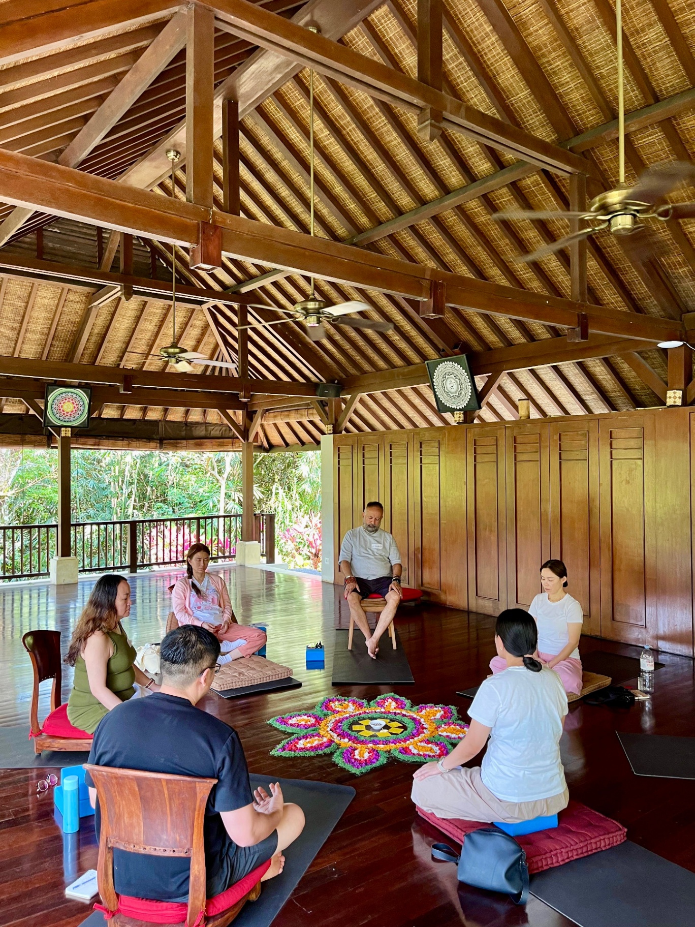 Group meditation in a Balinese pavilion at Being Sattvaa