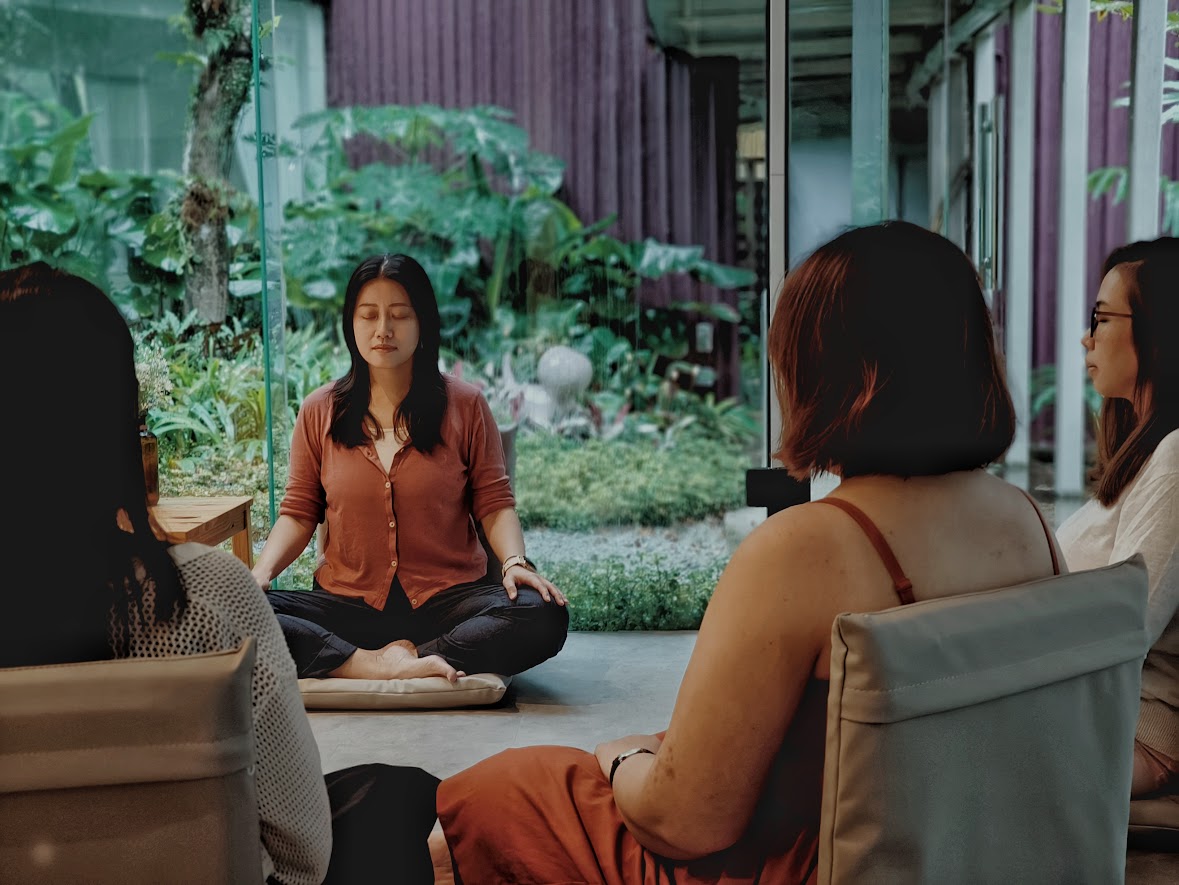 Erin leading a guided meditation with a small group at a Take A Pause mini retreat in Singapore